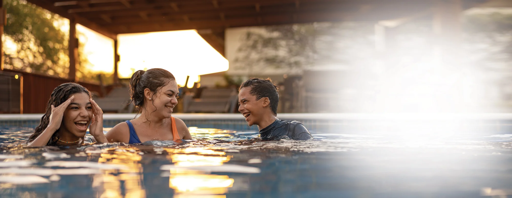 mom, daughter and son swimming in pool